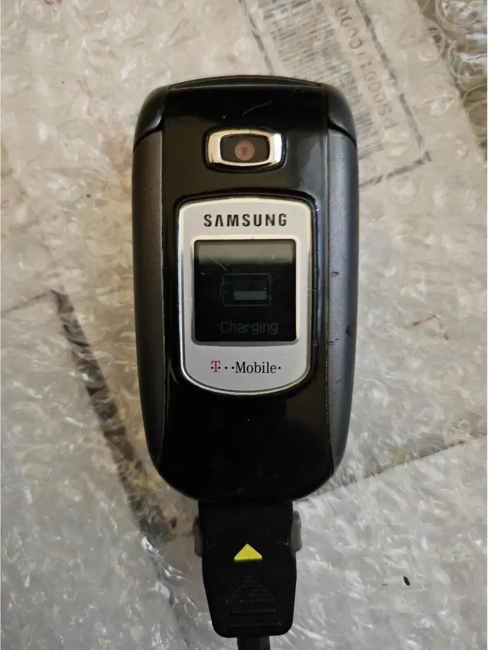 Nice vintage Samsung flip cell phone t-mobile. With Charger. Powers on & charges
